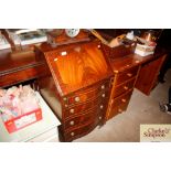 A mahogany serpentine fronted bureau; fitted with