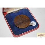 An unusual Spink & Son bronze medallion for the Co