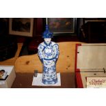 A blue and white Oriental figure with character ma