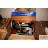 A Singer hand sewing machine in fitted case