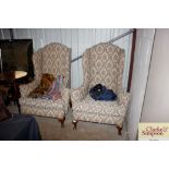 A pair of wing back armchairs on squat cabriole su