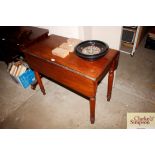 A mahogany 19th century dropleaf table fitted with