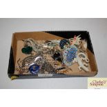A box containing various brooches in the form of l