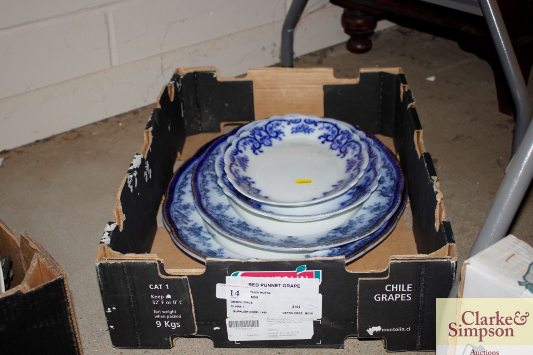 A box containing four blue and white meat plates