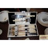 A cased set of fish servers and fish knives and fo