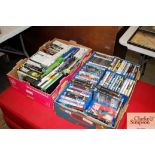 Two boxes containing various DVDs and games