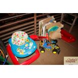 A child's baby walker, balance bike and other chil