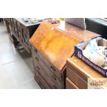 A mahogany four drawer bureau with presentation pl