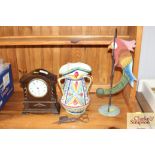 An oak cased mantel clock and a swinging parrot or