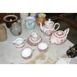 A quantity of red and white teaware