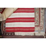 An approx 5'2" x 3' red and white rug