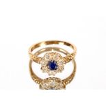 An 18ct gold sapphire and diamond cluster ring, Si