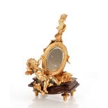 A decorative gilt bronze mirror, in the form of a