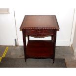 An unusual carved ,mahogany two tier occasional ta