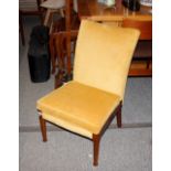 A Parker Knole nursing chair, raised on rounded ta