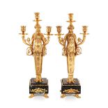 A pair of bronze Empire style figural three light