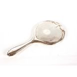A silver mounted dressing table hand mirror, with
