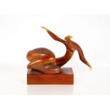 A gold coloured abstract sculpture, of a reclining figure 40cm long, 32c