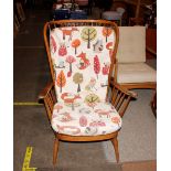 An Ercol cottage style stick back wing armchair