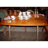 An Ercol dining table raised on square tapering su