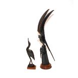 A carved horn model of a parrot; and another of a