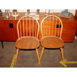 A set of Ercol stick back dining chairs, raised on