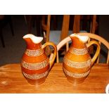 A pair of brown glazed French earthenware jugs