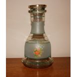 A vintage glass carafe with floral spray decoratio