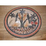 A Mexican pottery charger, decorated with birds am