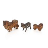 Three cold painted bronze dog figures in the manne