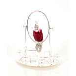 A silver plated and ruby glass parrot decanter set