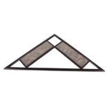 A triangular shaped decorative wall mirror with fa