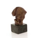 A bronze bust of a boy