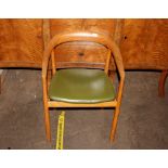 A 1970's elm tub shaped elbow chair