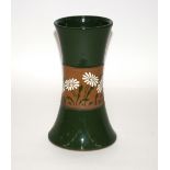 A green glazed pottery vase of waisted form, havin