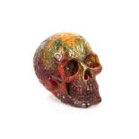 An amber coloured skull ornament, 17cm