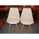 A set of four Mmilo tub shaped dining chairs