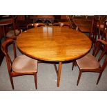 A circular Danish extending rosewood dining table by Johannes Anderson, with extra leaf, raised on s