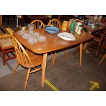 An Ercol dining table raised on tapering square se