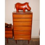A teak six drawer chest by Austin Suite, raised on rounded tapering supports,