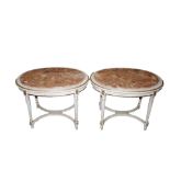 A pair of oval cream and gilt decorated lamp table