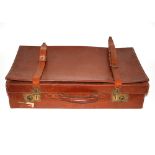 A vintage leather suitcase; a calf skin wallet; an