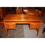 A teak G-plan style pedestal writing desk, fitted