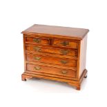 A Georgian style mahogany miniature chest, of two short and three