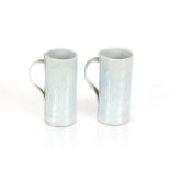 Two pale blue porcelain mugs, decorated with the e