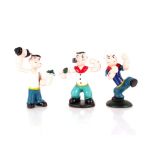 Three cast iron Popeye figures, 15cm