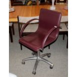An Eames style adjustable leather office ch
