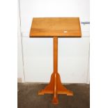 A light oak lectern raised on square column and qu