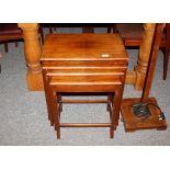 A nest of four graduated walnut occasional tables,