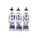 Three decorative blue and white china men figures
